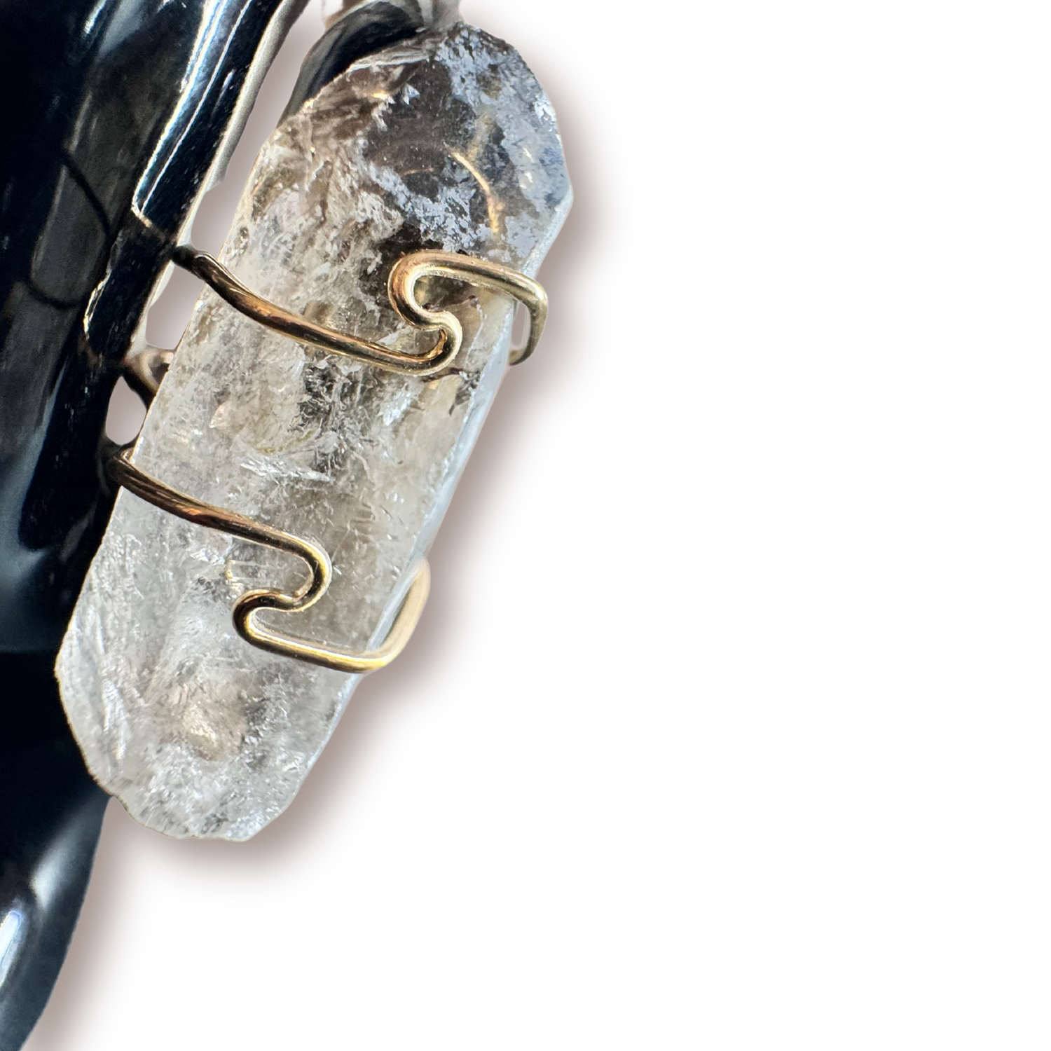 Close-up of the raw smoky quartz point wrapped in hand-formed gold wire on the Noir Majesty ring